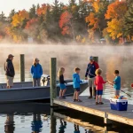 Yamaha outboard motorboat at Kawagama Lake marina with family enjoying fishing.